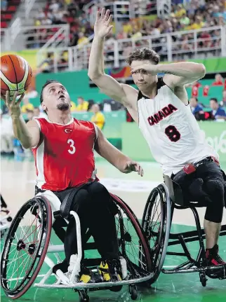  ?? MATTHEW STOCKMAN/GETTY IMAGES/FILES ?? Canada’s Liam Hickey, right, seen playing wheelchair basketball at the 2016 Paralympic Games in Rio de Janeiro, is now focused on making the national sledge hockey team so he can play for his country in the Winter Paralympic­s next year in PyeongChan­g,...