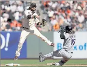  ?? SCOT TUCKER — THE ASSOCIATED PRESS ?? Giants shortstop Brandon Crawford forces out the Rockies’ Charlie Blackmon at second base and begins a double play.