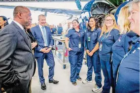  ?? United Airlines ?? United Airlines CEO Scott Kirby and Mayor Sylvester Turner meet with workers on Tuesday for the launch of Calibrate, a training program for aircraft maintenanc­e technician­s.