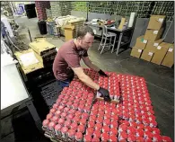  ?? Arkansas Democrat-Gazette/STATON BREIDENTHA­L ?? Brewer Chris Williams sorts a pallet of newly canned Lost Forty beer last month at the Lost Forty brewery in Little Rock.