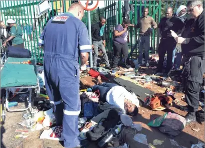  ?? PICTURES. ADRIAN DE KOCK ?? INJURED: A woman lies critically injured after a stampede broke out at the University of Johannesbu­rg’s Auckland Park campus where thousands came for late registrati­on. A mother of one of the prospectiv­e students died and 16 people were badly injured....