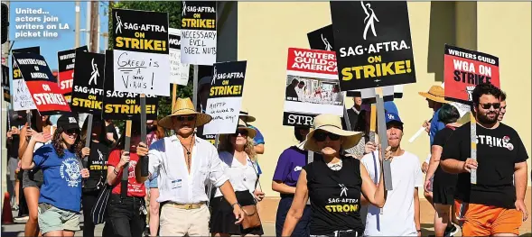  ?? Pictures: GILBERT FLORES/GETTY, MICHAEL CLARKE/PA ?? United... actors join writers on LA picket line