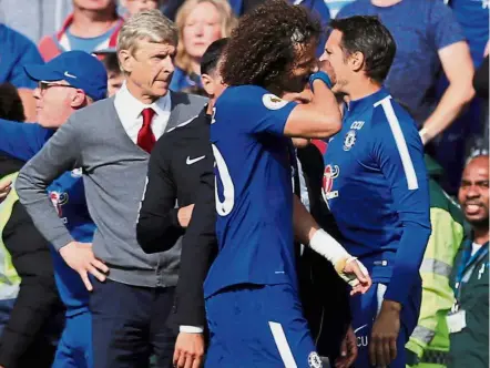  ?? — Reuters ?? Seeing red: Chelsea’s David Luiz (centre) walking off the pitch after being sent off in the English Premier League match against Arsenal at Stamford Bridge yesterday. The game ended 0- 0.