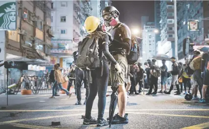  ??  ?? Rémy Soubanère’s photo Barricade Lovers features two Hong Kong protesters sharing a tender moment on Oct. 13. The photo is part of the exhibition Revolution of Our Times at the Polygon Gallery.