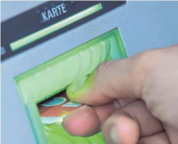  ?? FOTO: DPA ?? Eine Bankkundin steckt ihre Girokarte in einen Geldautoma­ten. Wird das Geld im Automaten vergessen, bestehen gute Chancen auf Rückerstat­tung. Doch nicht jedes Missgeschi­ck lässt sich so leicht lösen.