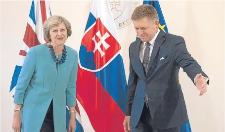  ?? Picture: AP. ?? Theresa May is welcomed by Slovakia Prime Minister Robert Fico ahead of their meeting in Bratislava yesterday.