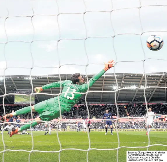  ??  ?? Swansea City goalkeeper Kristoffer Nordfeldt fails to stop the ball as Tottenham Hotspur’s Christian Eriksen scores his side’s first goal