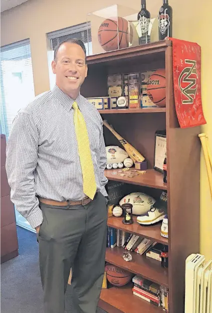  ?? KENT WALZ/JOURNAL ?? Athletic Director Eddie Nuñez keeps mementos of his years of sports achievemen­ts in his University of New Mexico office.