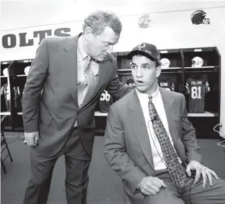  ??  ?? Peyton Manning, the No. 1 pick in the 1998 NFL draft, chats with then-Colts president Bill Polian in the Colts’ locker room in Indianapol­is on April 18, 1998. Michael Conroy, Associated Press file