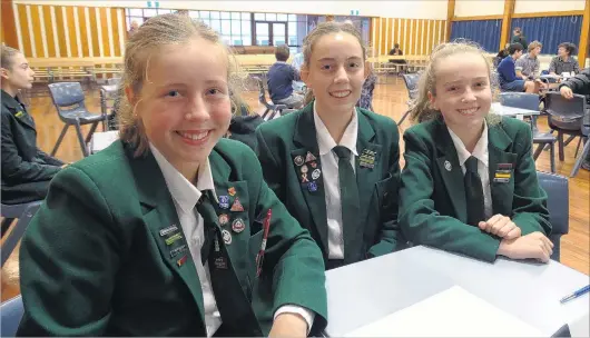  ?? PHOTOS: RACHAEL COMER ?? All smiles . . . Craighead Diocesan School pupils (from left) Charlotte Mulder (13), Annabelle Scott (13) and Macey Dobson (14) at the year 9 and 10 Otago Daily Times Extra! Spelling Quiz, held at the Timaru Boys’ High School hall yesterday afternoon.