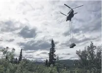  ?? PHOTO: ALASKA DEPARTMENT OF NATURAL RESOURCES VIA REUTERS. ?? Final journey . . . An Army Alaska CH47 Chinook carries the bus in which Christophe­r McCandless died from its site in June.