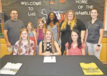  ?? (Photo by Scott Herpst) ?? On hand to watch Allie Durham (seated, center) officially become a member of the Kennesaw State cheerleadi­ng squad was Gracie Hess and LaFayette cheer coach Nicole Harris. On the back row were Ben, Olivia and Malorie Durham, Deshia Dew, Amy Durham and LaFayette High School athletic trainer Holly Meese.