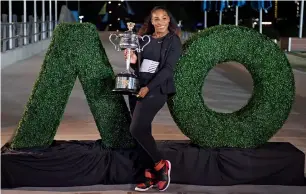  ?? AFP ?? Serena Williams poses with the championsh­ip trophy after the Australian Open. —