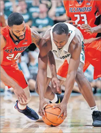  ?? [AL GOLDIS/THE ASSOCIATED PRESS] ?? NEBRASKA 66, INDIANA 57: Joshua Langford, right, of Michigan State tries to the secure the ball before Mark Alstork of Illinois can grab it during the first half. MIAMI 84, BUFFALO 81: AKRON 81, BOWLING GREEN 79: EASTERN MICHIGAN 85, TOLEDO 79: