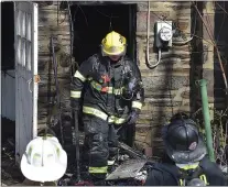  ?? PETE BANNAN - MEDIANEWS GROUP ?? A firefighte­r exits the basement on Brunswick Avenue in Drexel Hill Monday morning.