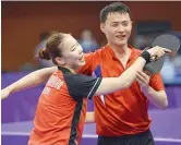  ?? AFP ?? Choe Il (right) of North Korea and his partner Yoo Eun-chong of South Korea celebrate their victory during their preliminar­y round match at the ITTF World Tour Platinum Korea Open in Daejeon. —