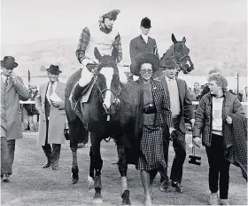  ??  ?? Country life: Andrew Elliott, in hunting attire, escorts Pearlyman at Cheltenham in 1987