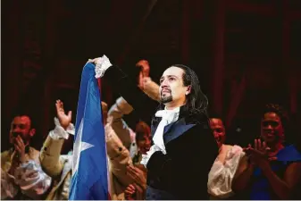  ?? Erika P. Rodriguez / New York Times ?? Lin-Manuel Miranda lifts the Puerto Rican flag as he plays the title role in “Hamilton” on the opening night of a 17-day run in San Juan on Friday. Miranda’s parents are from the island.