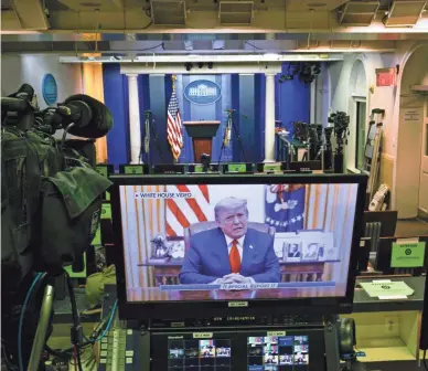  ?? AP ?? President Donald Trump is seen in a prerecorde­d video on a television monitor in an empty press briefing room at the White House in Washington, D.C., after the U.S. House impeached him on Wednesday.