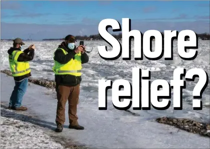  ?? U.S. ARMY PHOTO BY WILLIAM DOWELL ?? U.S. Army Corps of Engineers, Detroit District, field team Senior Hydraulic Engineer Matt McClerren, left, and Hydraulic Technician Jon DePhillips document St. Clair River ice jams on the St. Clair River at Algonac State Park on Feb. 3.