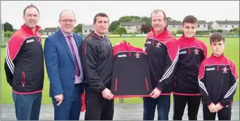  ??  ?? John Clifford of Clifford Electrical presenting Niall Murray St. Marys GAA club with club tracksuits for the Under 14 panel.