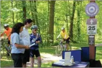  ??  ?? Mansion House Visitor Experience Associate Benjamin Adams, center, discusses the history of the Oneida Community Mansion House with cyclist Joan Kasprowicz, right, and Patti Meakin, of the city Parks and Recreation Department on Thursday, July 12, 2018.