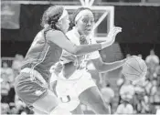  ?? LUIS M. ALVAREZ/AP ?? Miami forward Beatrice Mompremier attempts to go around Florida Gulf Coast guard Destiny Washington­Mabon during a first round game Friday in Coral Gables.