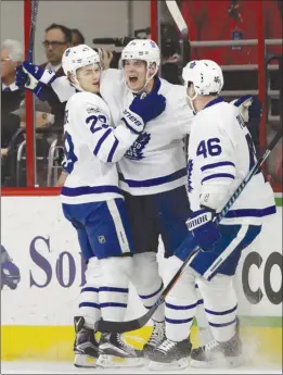  ?? The Associated Press ?? Toronto Maple Leafs centre Auston Matthews, middle, is congratula­ted by William Nylander, left, and Roman Polak (46) after scoring against the Carolina Hurricanes during NHL action in Raleigh, N.C., on Sunday. The Leafs won 4-0.