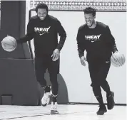  ?? Courtesy of Miami Heat ?? Jimmy Butler, right, with Udonis Haslem during a practice at Walt Disney World, considered opting out of the restart.