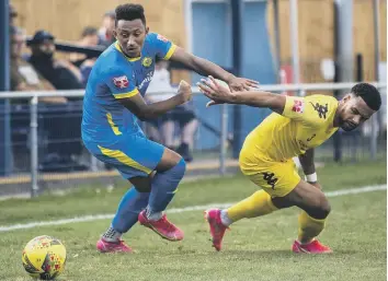  ??  ?? Dion Sembie-Ferris (blue) in action for Peterborou­gh Sports against Leiston. Photo: James Richardson.