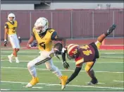  ?? PHOTO BY TRACEY ROMAN ?? Warren’s Dajon Hancox gets past Wilson’s Johnell Gray on a touchdown run last week. Warren went on to a 53-0 victory and will face La Serna tonight.