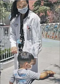  ?? Wesley Lapointe Los Angeles Times ?? A CHILD waits to get a COVID vaccine at Children’s Hospital Los Angeles in June. Respirator­y viruses have spiked this fall.