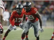  ?? PAUL VERNON — THE ASSOCIATED PRESS FILE ?? Ohio State defensive end Tyquan Lewis (59), right, and linebacker Jerome Baker defend during a 2016 game.