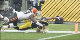  ?? DONWRIGHT — THE ASSOCIATED PRESS ?? Pittsburgh Steelers wide receiver Chase Claypool (11) stretches, trying to score a touchdown past Cleveland Browns defensive tackle Sheldon Richardson (98) during the second half on Sunday, in Pittsburgh. Claypool came up short but the Steelers scored on the next play, winning 38-7.