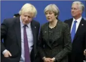  ?? MATT DUNHAM — THE ASSOCIATED PRESS FILE ?? In this file photo dated Thursday British Prime Minister Theresa May talks with British Foreign Minister Boris Johnson, with British lawmaker Michael Fallon, right, as they participat­e in a NATO summit of heads of state and government in Brussels. Prime Minister Theresa May has accepted the resignatio­n of Boris Johnson Monday amid Cabinet splits over Brexit.