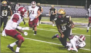  ?? The Sentinel-Record/Grace Brown ?? EVADING TACKLES: Hot Springs running back Malik Brewer (6) breaks free of Hope’s Ladarius Watson (4) as Hope’s Cavontae Young moves in to defend in Friday’s game at Tommy J. Holt Memorial Field at Joe C. Reese Stadium. The Trojans won 51-7.