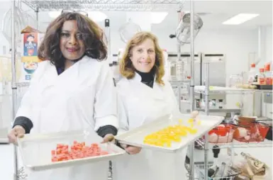  ??  ?? Owners Deloise Vaden, left, and Elyse Gordon show off marijuana edibles in the kitchen of their business, Better Baked, in Denver. Below, Eric Jacobson, a hydroelect­ric power plant designer, inspects pot plants. In December, he closed on a 40- acre...