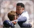  ?? CARLOS OSORIO - THE ASSOCIATED PRESS ?? Detroit Tigers designated hitter Miguel Cabrera greets his family after his 3,000th career hit during the first inning of the first baseball game of a doublehead­er against the Rockies, Saturday, April 23, 2022, in Detroit.