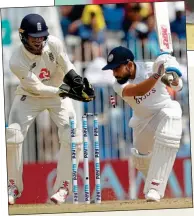  ??  ?? CAN’T BELIEVE IT: The great Kohli is stunned by Moeen’s magic and takes time to trudge off