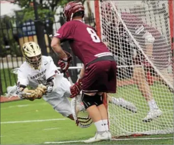  ?? FOR DIGITAL FIRST MEDIA — MATT CHANDIK ?? Haverford School’s Johnny Nostrant dives around the crease to try to score in mid-air, but he’s unable to beat Culver Academy goalie Matt Schmidt Sunday. Schmidt made 13 saves in Culver’s 9-5 win.