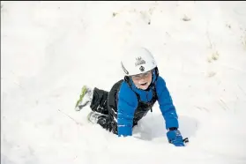  ?? HELEN H. RICHARDSON / The Denver Post ?? Eli Strong, 8, laughs after taking a spill in the snow on his brand-new sled Monday at Waneka Lake Park in Lafayette.