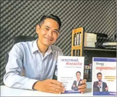  ?? HENG CHIVOAN ?? Teacher and author Bou Panha show his French language book at home in the capital’s Stung Meanchey district on November 28.