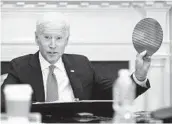  ?? PATRICK SEMANSKY AP ?? President Joe Biden holds up a silicon wafer at the virtual CEO summit on semiconduc­tors Monday.