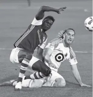  ??  ?? Colorado Rapids forward Dominique Badji and Minnesota United defender Brent Kallman go after the ball during the first half Saturday night. Andy Cross, The Denver Post