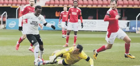  ??  ?? Siriki Dembele is about to score for Posh at Swindon last season. Photo: Joe Dent/theposh.com