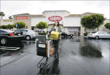  ?? Frederic J. Brown AFP via Getty Images ?? INSTACART worker Monica Ortega leaves a North Hollywood Ralphs with a grocery order. The delivery company says a nationwide strike over health and pay issues is having “absolutely no impact” on its business.