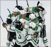  ?? JASON FRANSON — THE ASSOCIATED PRESS ?? Dallas’ Joe Pavelski, center, and teammates celebrate a goal against Calgary during third period Sunday.