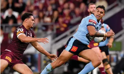  ?? Photograph: Darren England/AAP ?? The Blues’ Latrell Mitchell gets past the Maroons’ Xavier Coates to score a try during game two of the 2021 State of Origin series between Queensland and NSW.