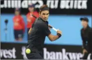  ?? TREVOR COLLENS - THE ASSOCIATED PRESS ?? Switzerlan­d’s Roger Federer plays a shot during his match against at Frances Tiafoe of the United States at the Hopman Cup in Perth, Australia, Tuesday, Jan. 1, 2019.