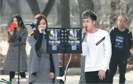  ?? PROVIDED TO CHINA DAILY ?? Young people livestream a musical performanc­e from a park on March 25, illustrati­ng the sort of content that meets ethical standards.